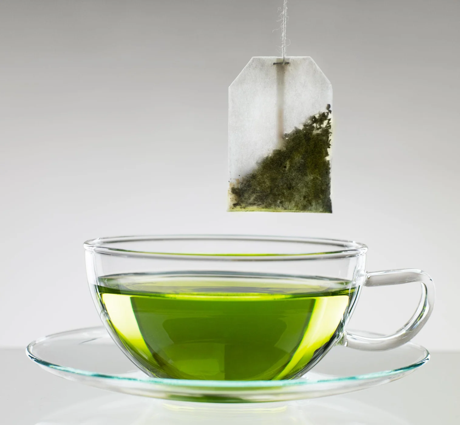 Golden green tea served in a glass cup